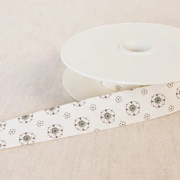 Biais "Fleurs" écru et kaki 25mm au mètre Biais "Fleurs" écru et kaki 25mm au mètre